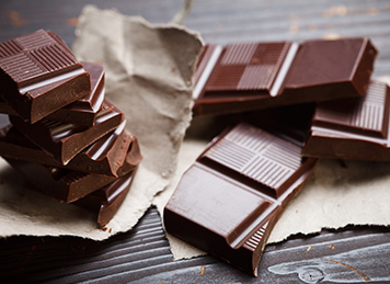 Hot tea in a kettle with cup next to a lemonand mint